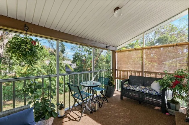 a balcony with furniture and garden view