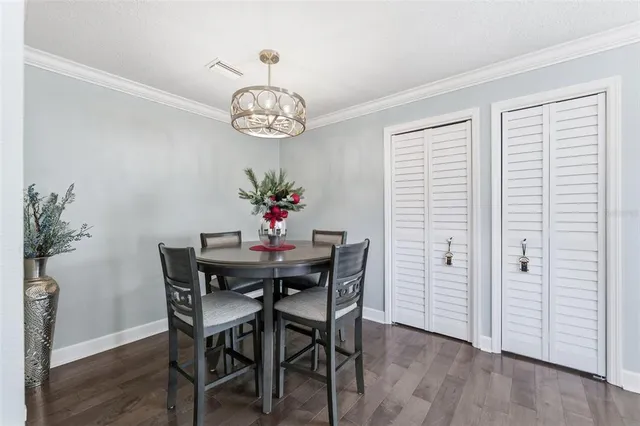 a view of a dining room with furniture wooden floor and chandelier