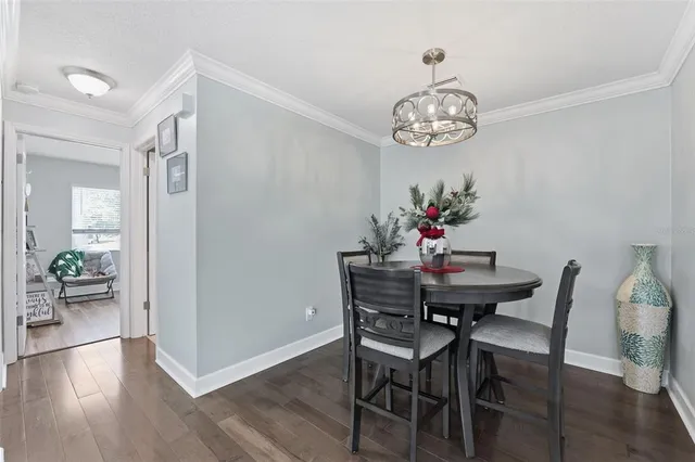 a view of a dining room with furniture wooden floor and a chandelier