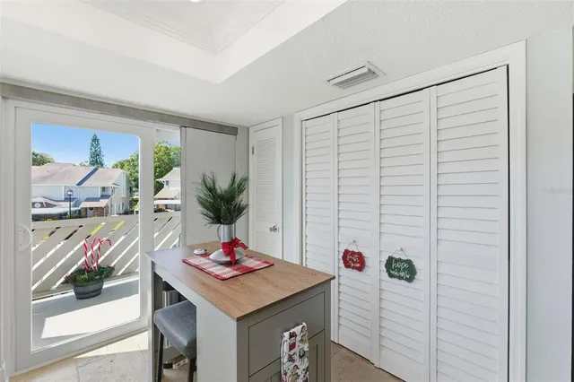 a view of a dining room with a table and chairs