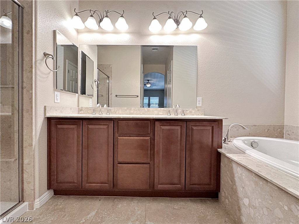 71 Newton Ridge Way Las Vegas, NV 89183 - Photo 31 of 40 Dual vanities and a soaking tub provide a relaxing, well-appointed bathroom retreat.