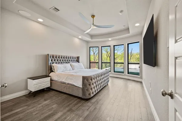 a spacious bedroom with a bed and a large window