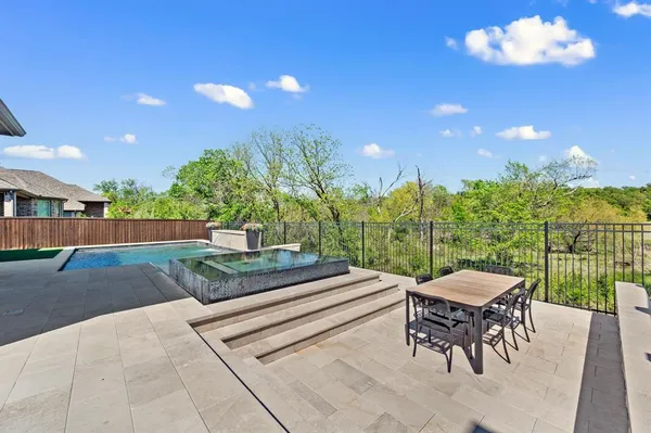 a outdoor space with a table and chairs