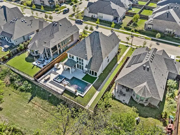 an aerial view of houses with a yard