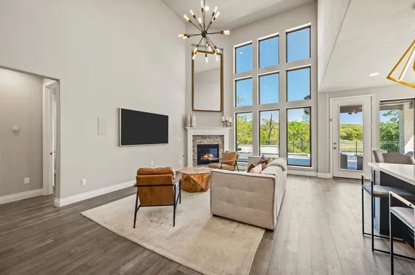 a living room with furniture fireplace and flat screen tv