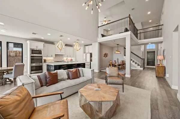 a living room with furniture and a chandelier
