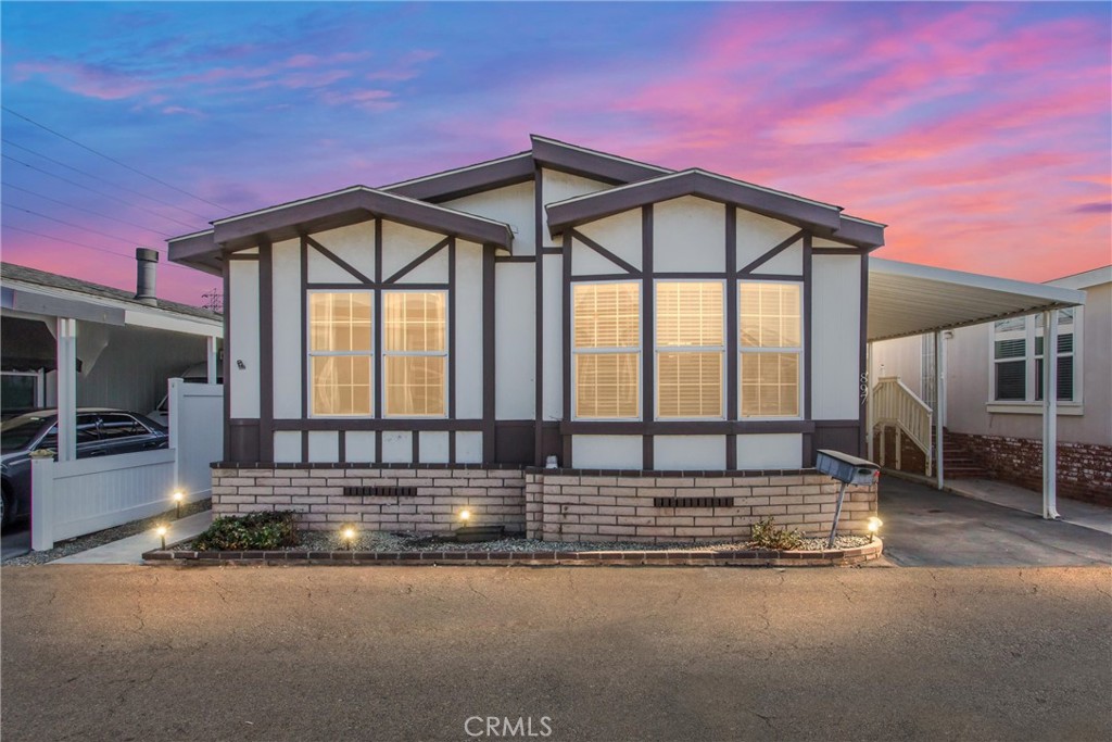 8681 Katella Avenue, Unit 897 Stanton, CA 90680 - Photo 1 of 31 a view of a house with a floor to ceiling window and brick wall