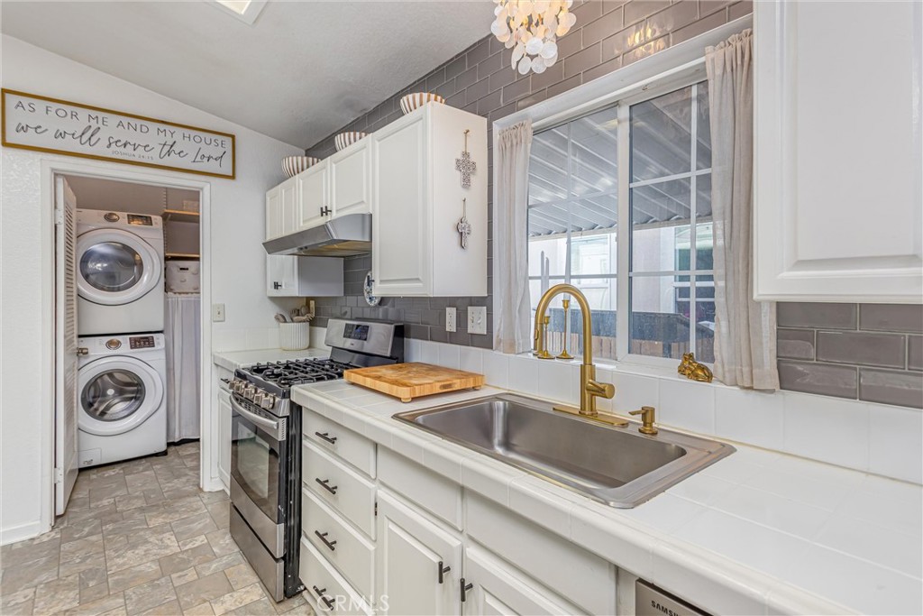 8681 Katella Avenue, Unit 897 Stanton, CA 90680 - Photo 11 of 31 a kitchen with stainless steel appliances granite countertop a sink stove and a granite counter top