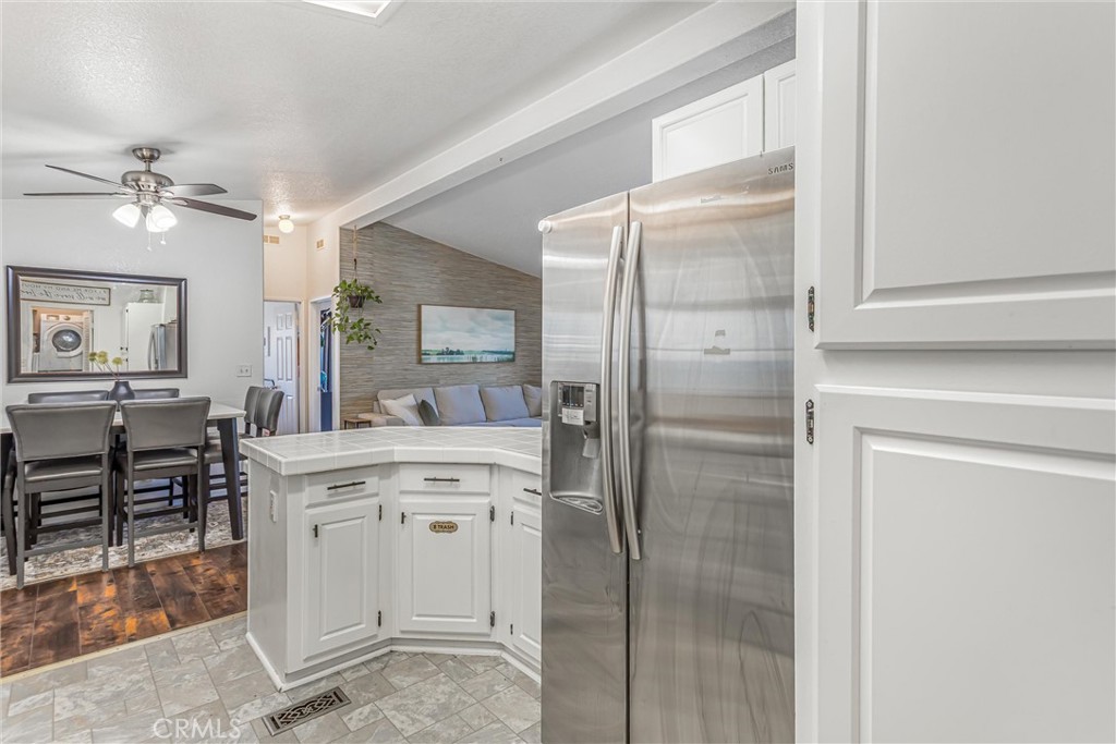 8681 Katella Avenue, Unit 897 Stanton, CA 90680 - Photo 12 of 31 a kitchen with cabinets and chairs