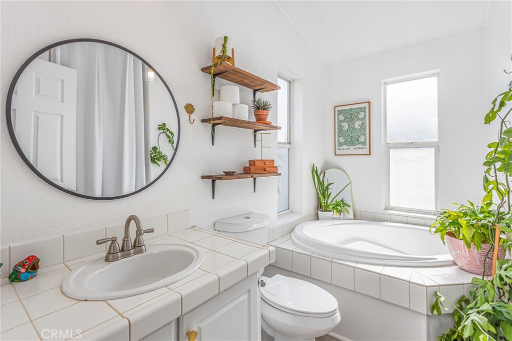 8681 Katella Avenue, Unit 897 Stanton, CA 90680 - Photo 21 of 31 a bathroom with a sink mirror and toilet