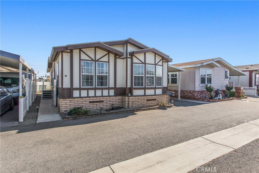 8681 Katella Avenue, Unit 897 Stanton, CA 90680 - Photo 4 of 31 a view of a house with a yard
