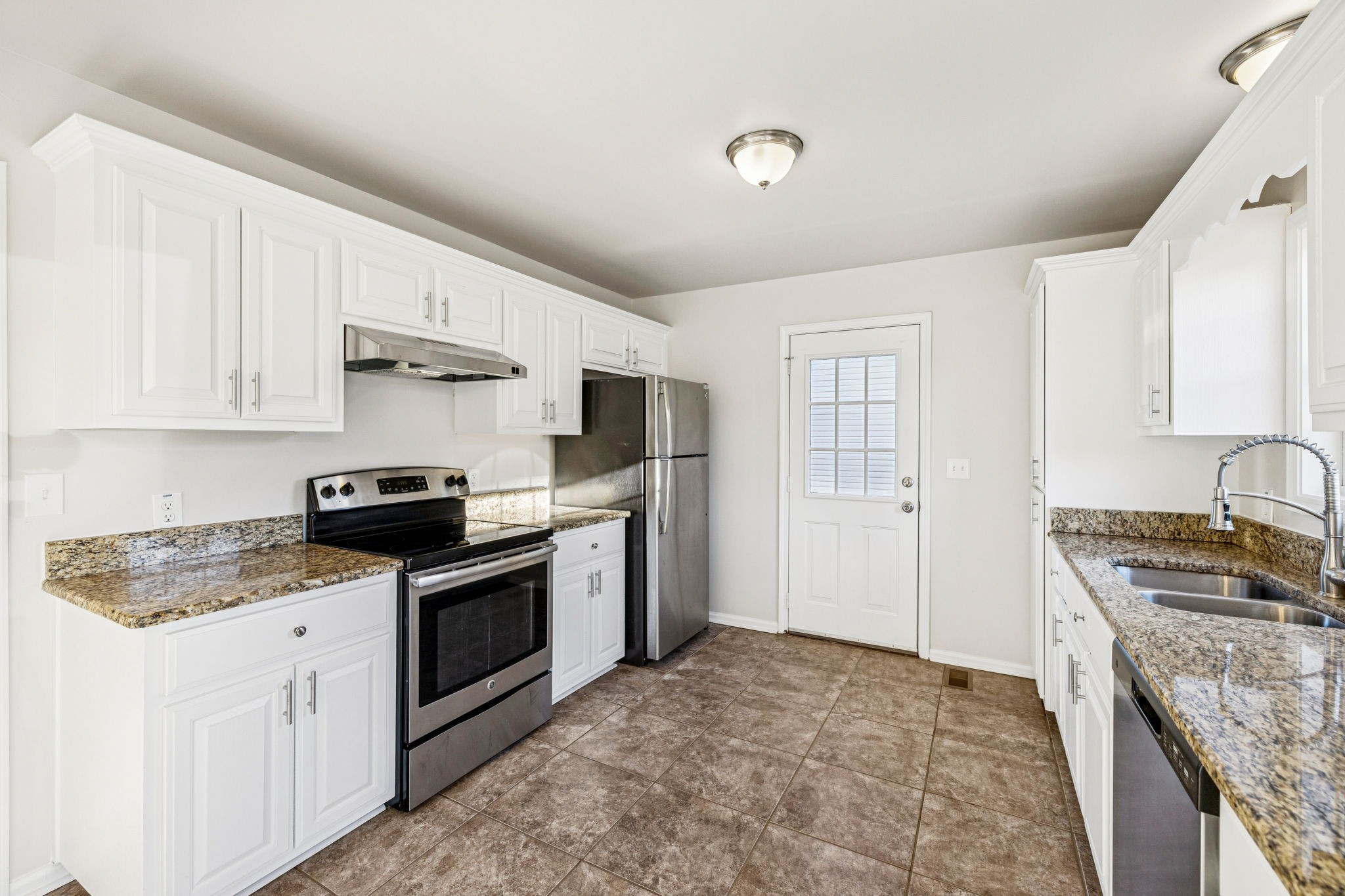 2995 Pipkin Hills Drive Spring Hill, TN 37174 - Photo 11 of 43 a kitchen with stainless steel appliances granite countertop a stove sink and refrigerator