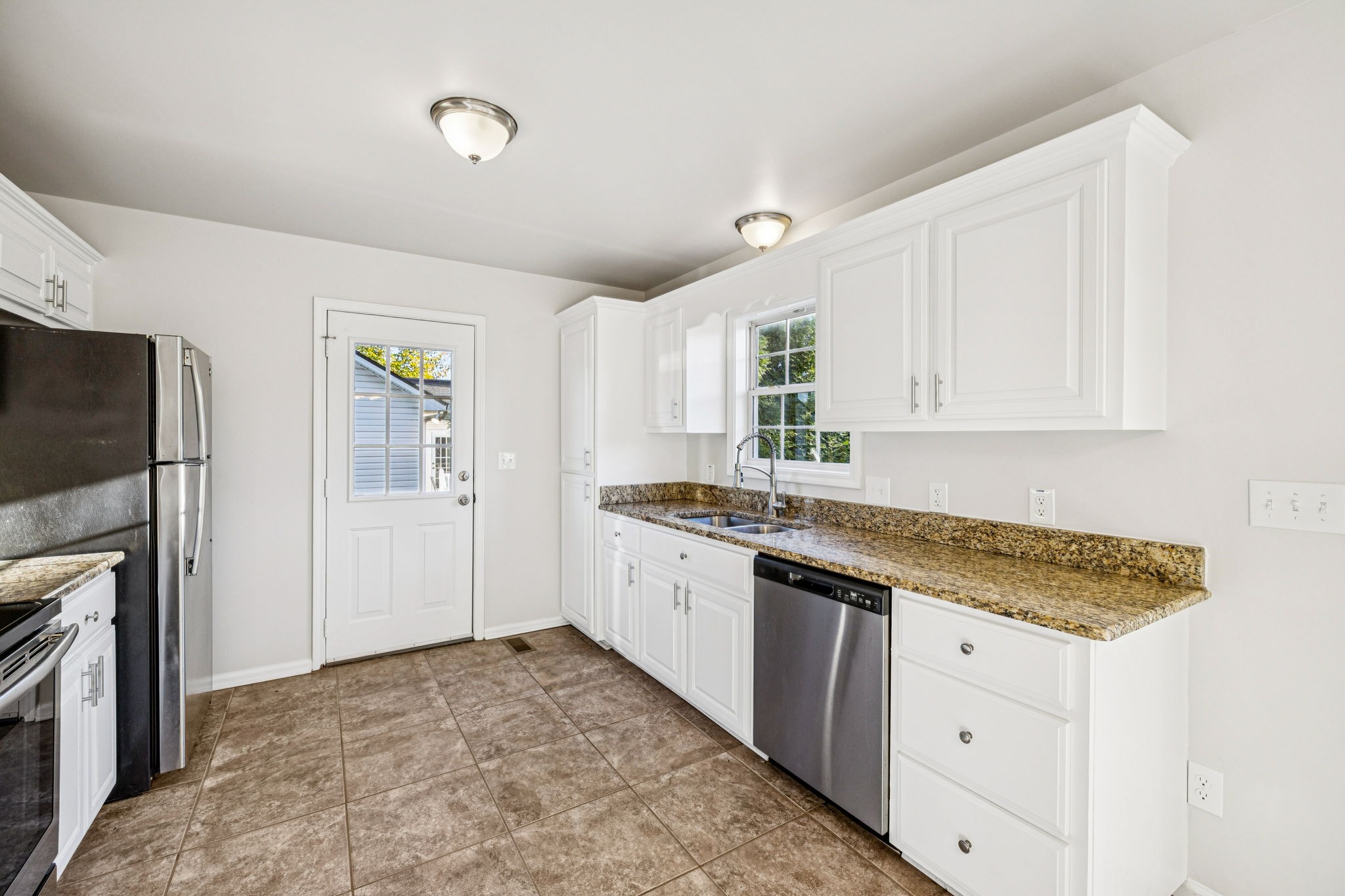 2995 Pipkin Hills Drive Spring Hill, TN 37174 - Photo 12 of 43 a kitchen with granite countertop a sink stainless steel appliances and cabinets