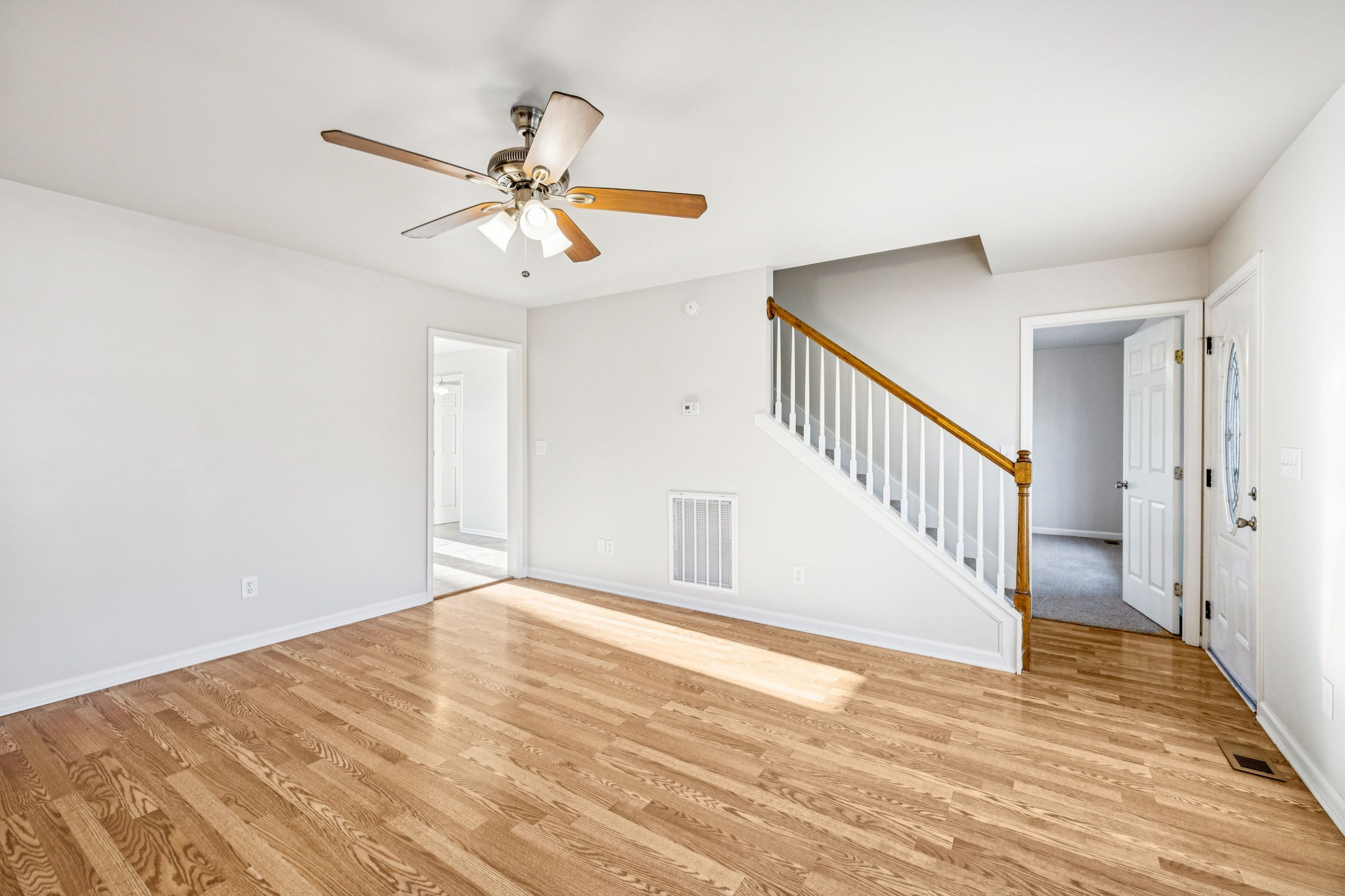 2995 Pipkin Hills Drive Spring Hill, TN 37174 - Photo 17 of 43 a view of an empty room with wooden floor and a ceiling fan
