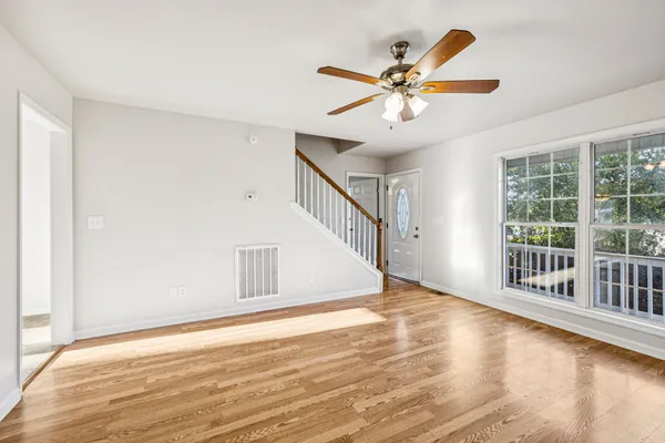 a view of an entryway with wooden floor