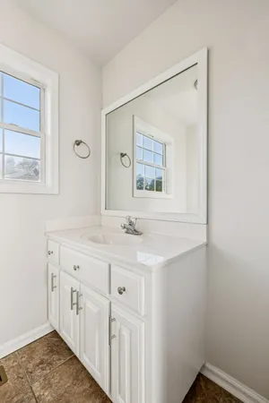 a bathroom with a sink a vanity and a mirror