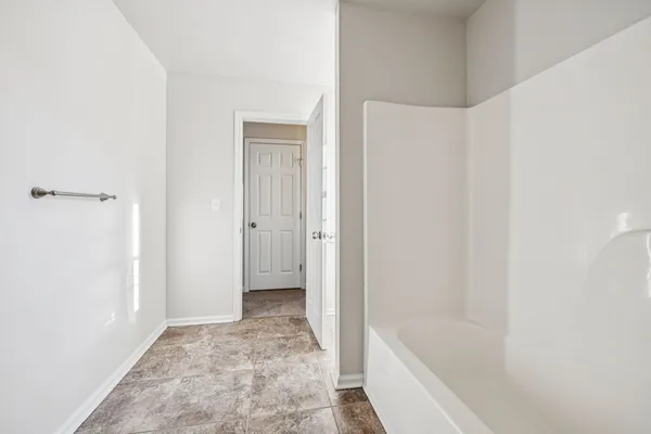 a bathroom with a tub and shower