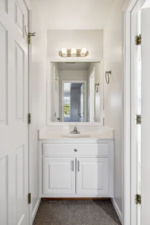 a bathroom with a sink vanity and a mirror