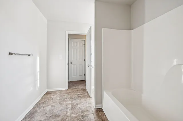 a bathroom with a tub and shower