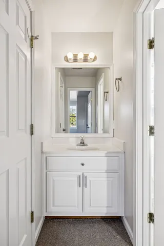 a bathroom with a sink vanity and a mirror