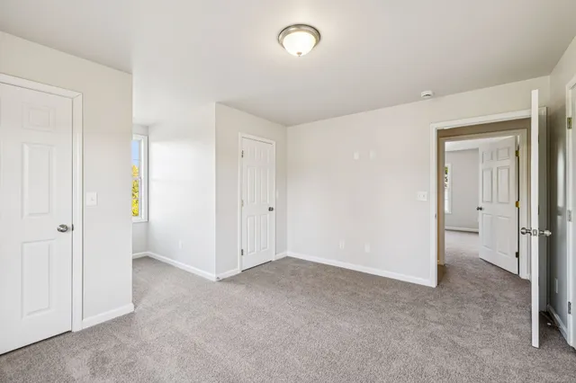 a view of an empty room and closet area
