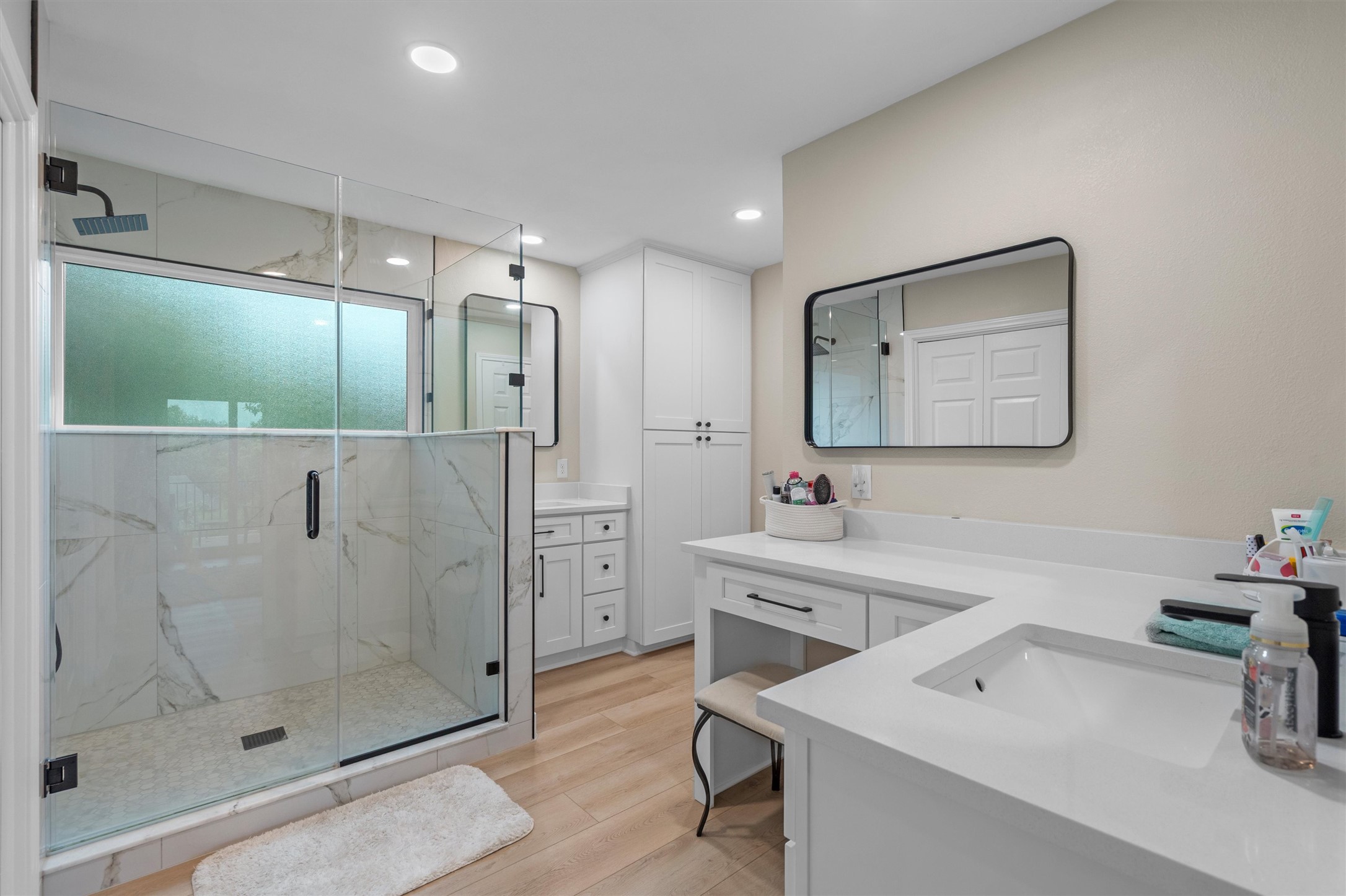307 Hurst Creek Road Austin, TX 78734 - Photo 29 of 40 Modern bathroom featuring a glass-enclosed shower with white marble-look tile surround and a rain showerhead