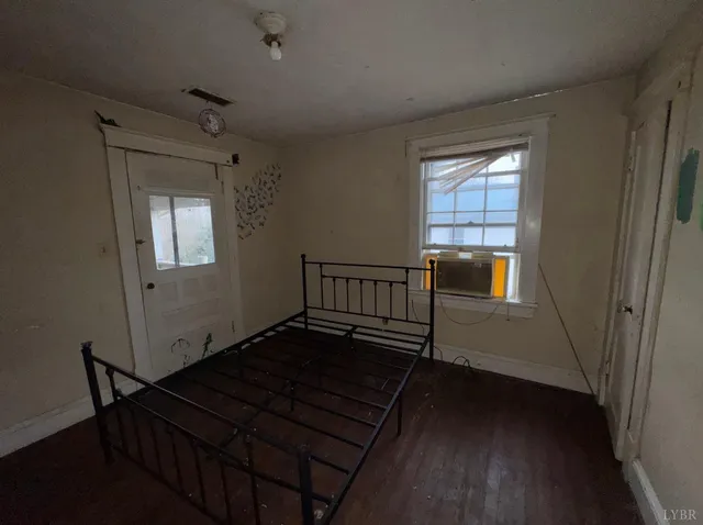 a view of an empty room and wooden floor