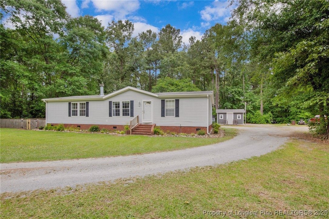 7263 Beaver Dam Road Stedman, NC 28391 - Photo 1 of 45 a view of a yard in front of a house with large trees