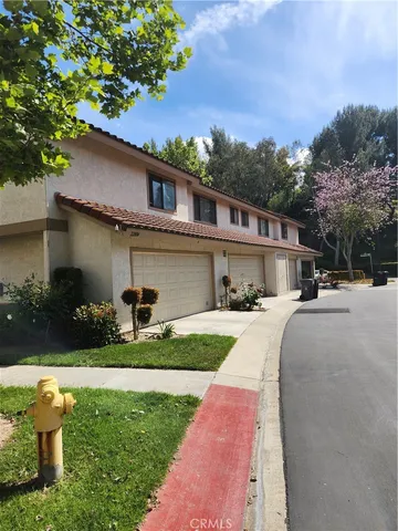 a front view of a house with a yard and porch