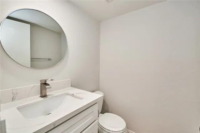 a white toilet sitting next to a bathroom sink