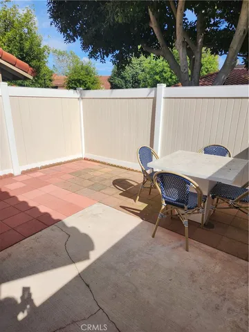 a backyard of a house with table and chairs