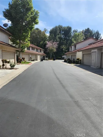 a front view of a house with a street