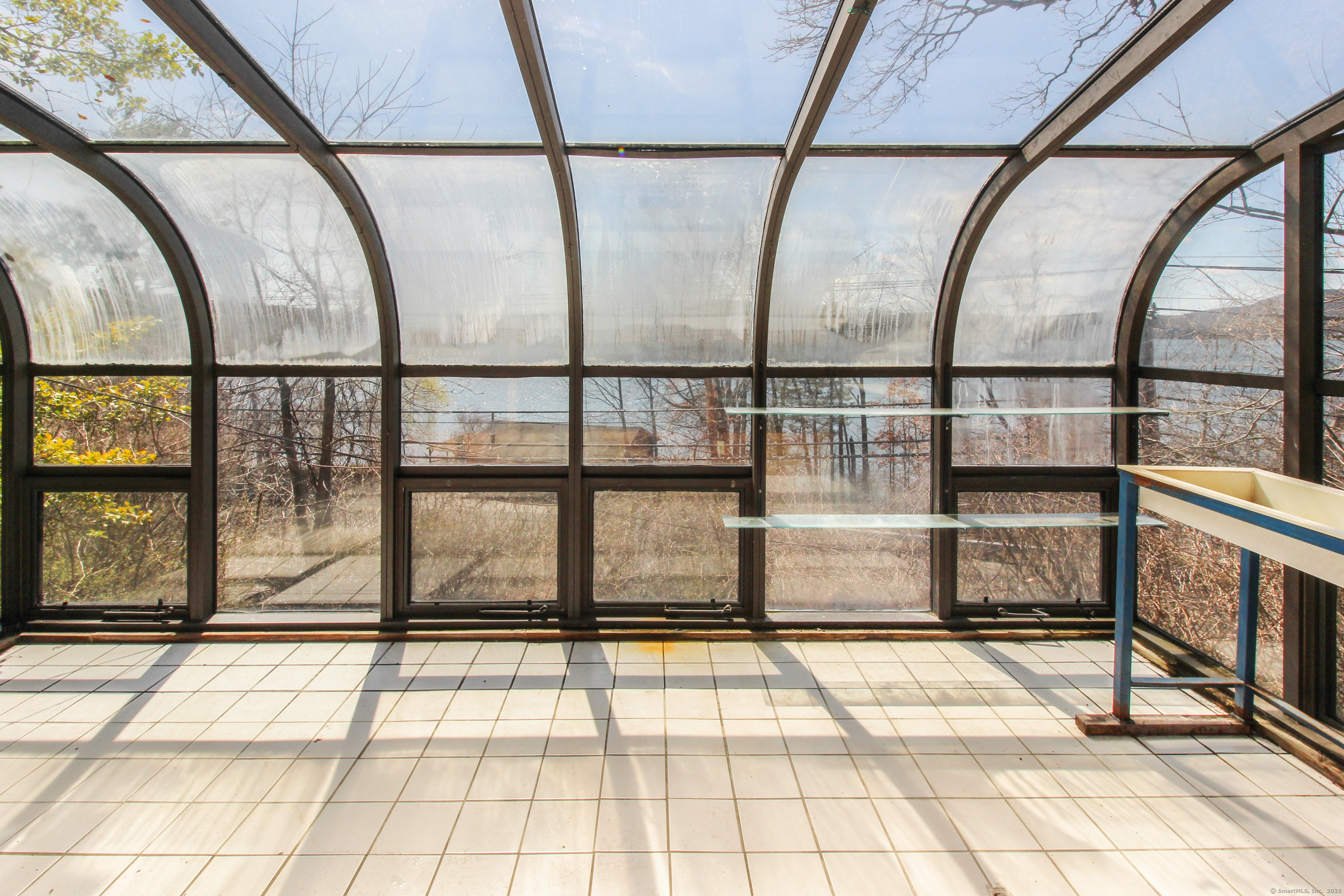 279 Candlewood Lake Road Brookfield, CT 06804 - Photo 11 of 40 a view of an empty room with a floor and large windows
