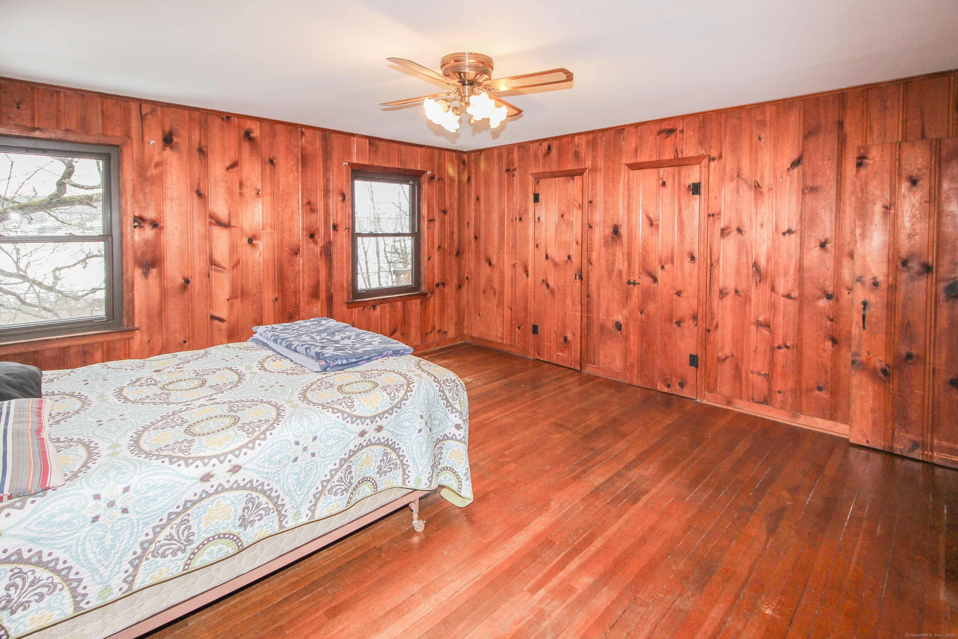 279 Candlewood Lake Road Brookfield, CT 06804 - Photo 16 of 40 a bedroom with a bed and a chandelier