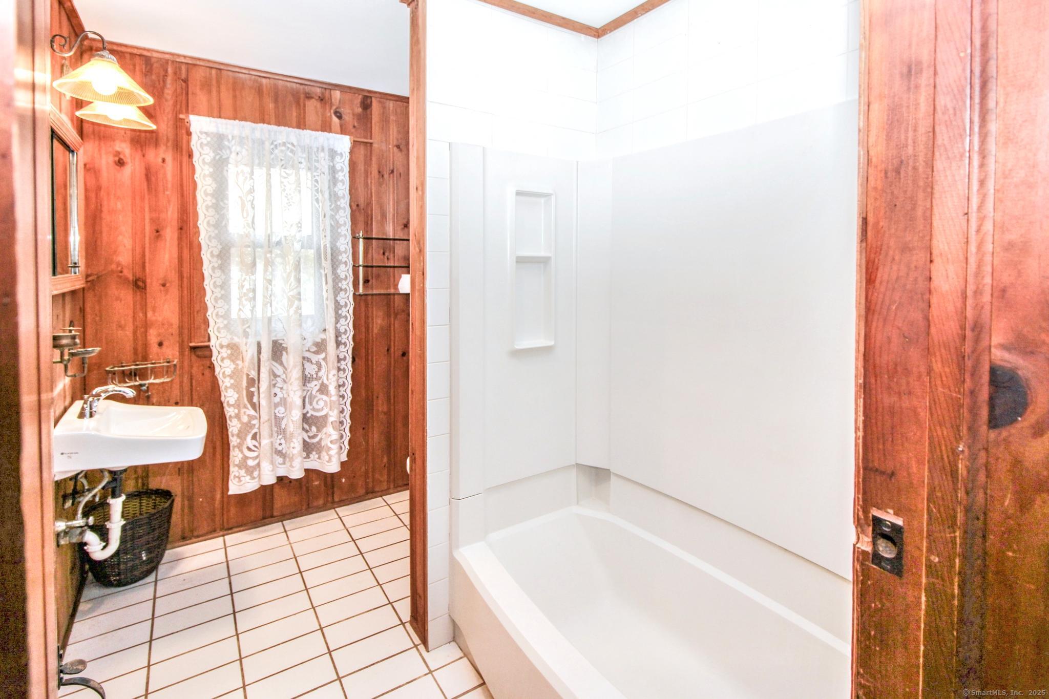 279 Candlewood Lake Road Brookfield, CT 06804 - Photo 17 of 40 a bathroom with a bathtub and shower