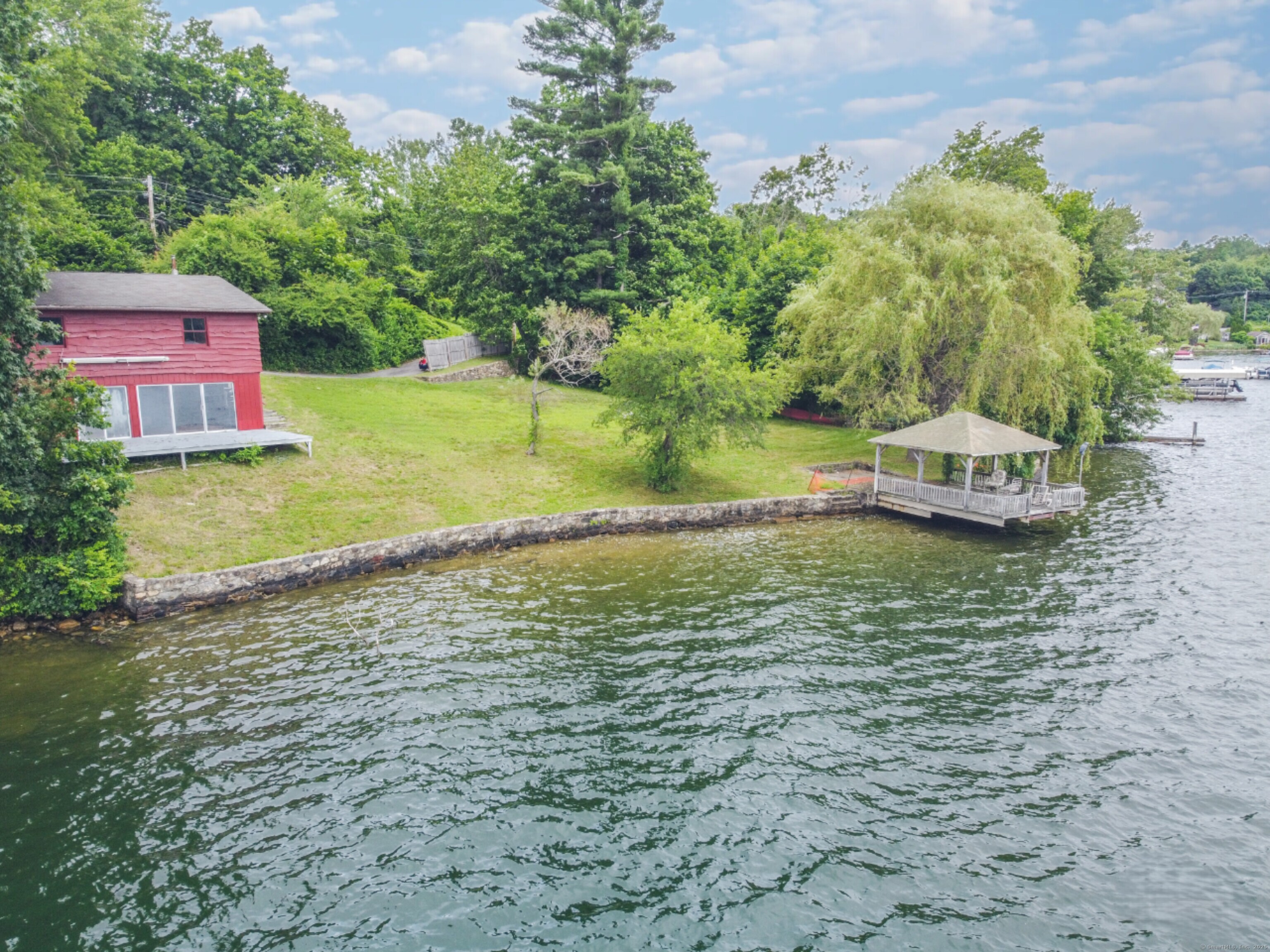 279 Candlewood Lake Road Brookfield, CT 06804 - Photo 3 of 40 a swimming pool with trees in the background