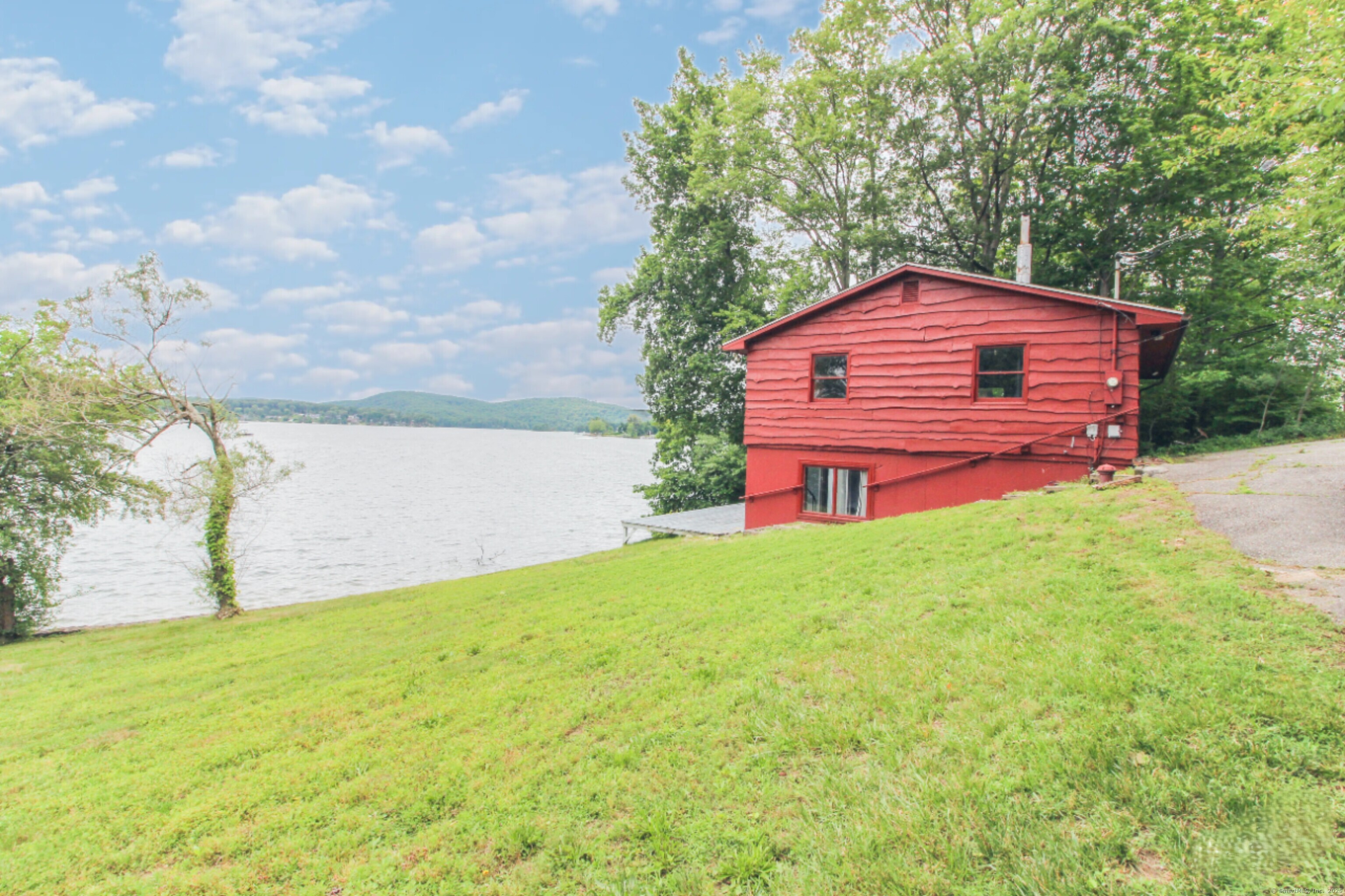 279 Candlewood Lake Road Brookfield, CT 06804 - Photo 33 of 40 a backyard of a house with table and chairs