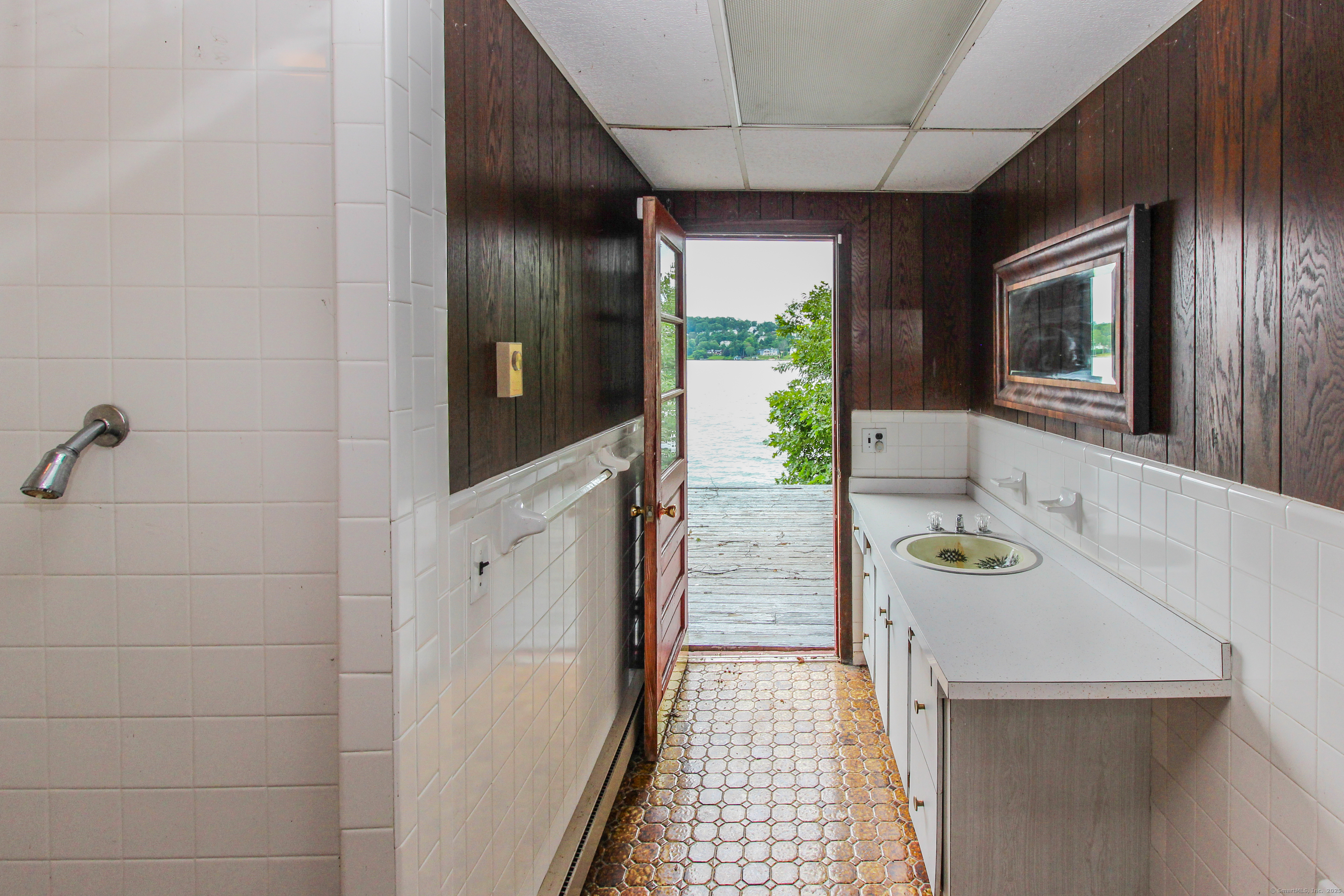 279 Candlewood Lake Road Brookfield, CT 06804 - Photo 37 of 40 a bathroom with a sink and mirror with bathtub
