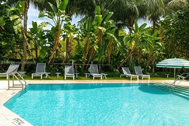 a view of a swimming pool with a yard