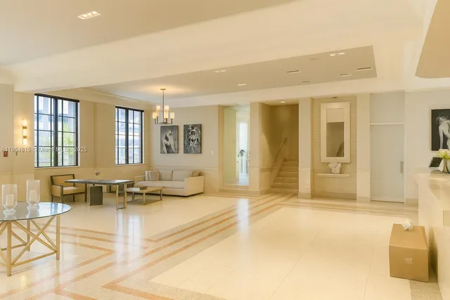 a living room with furniture and next to a window