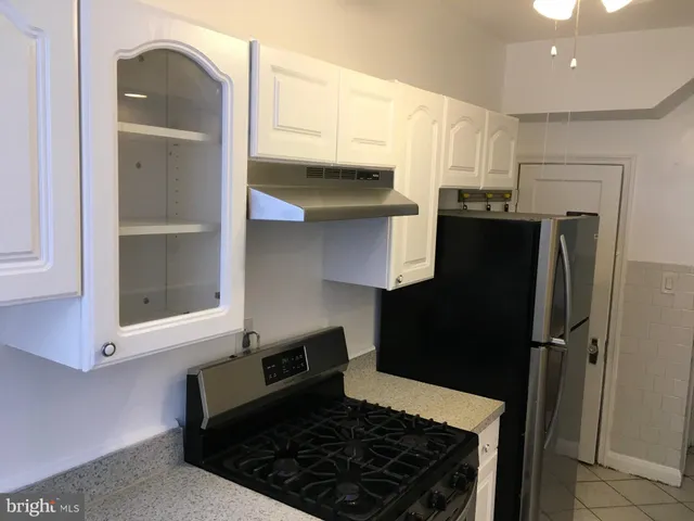 a kitchen with stainless steel appliances granite countertop a refrigerator and a stove