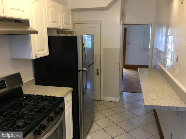 a kitchen with a refrigerator and a sink