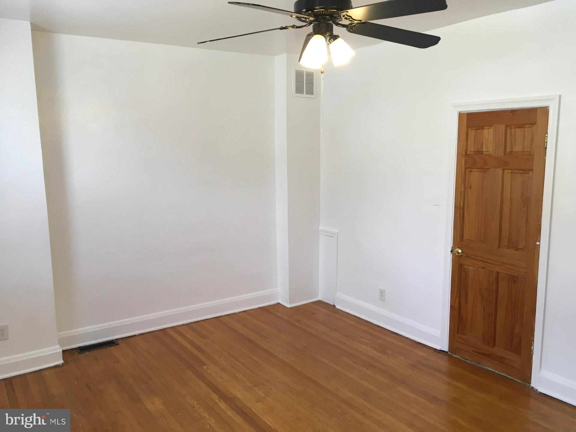 2477 West Cold Spring Lane Baltimore, MD 21215 - Photo 22 of 35 an empty room with wooden floor closet and fan