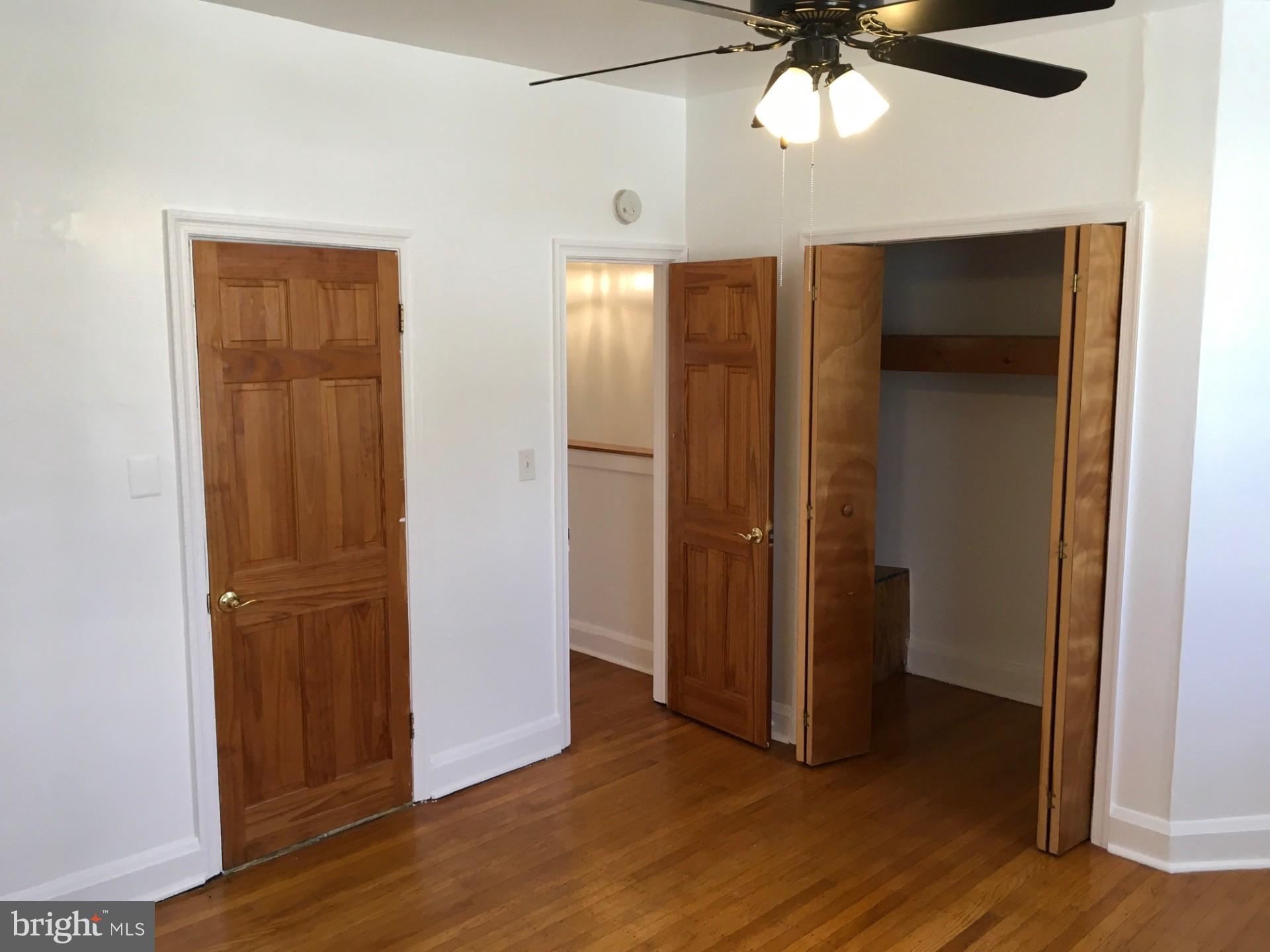 2477 West Cold Spring Lane Baltimore, MD 21215 - Photo 23 of 35 an empty room with wooden floor closet and windows