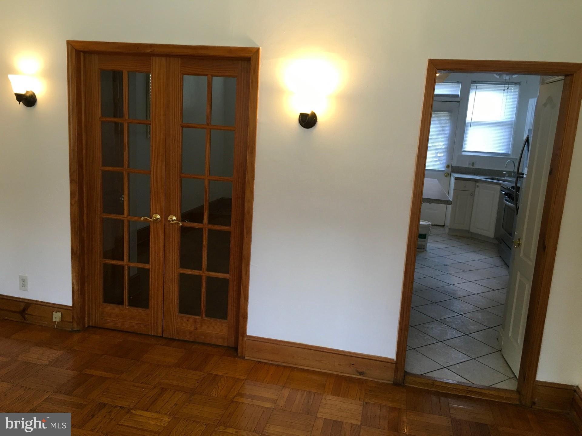 2477 West Cold Spring Lane Baltimore, MD 21215 - Photo 4 of 35 an empty room with wooden floor and windows