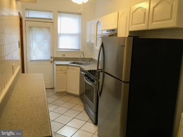 a stove top oven sitting inside of a kitchen