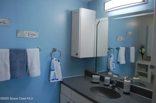a bathroom with a sink and vanity