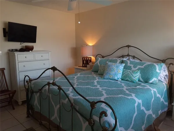 a bedroom with a bed and flat screen tv