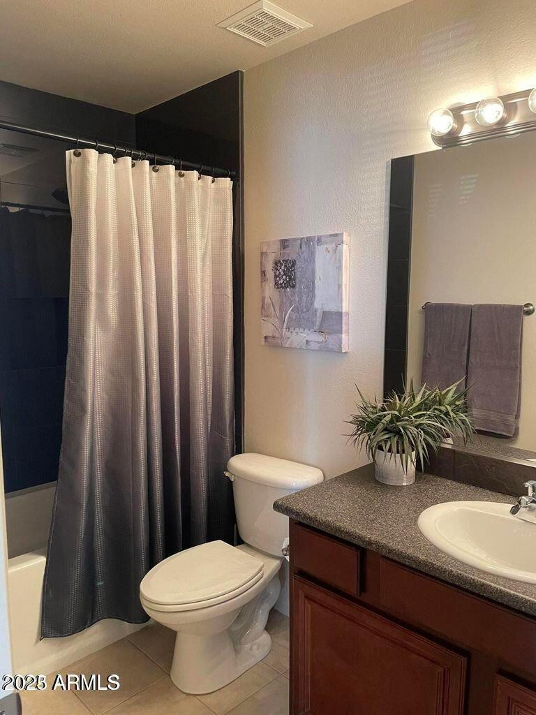 10115 East Mountain View Road, Unit 2036 Scottsdale, AZ 85258 - Photo 5 of 8 a bathroom with a sink a toilet and mirror