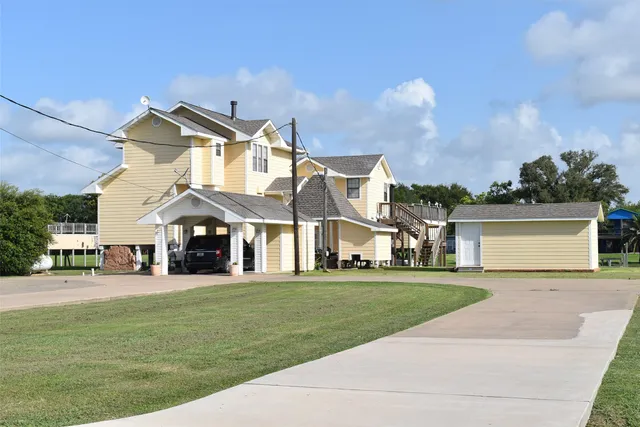 a front view of a house with a garden and yard
